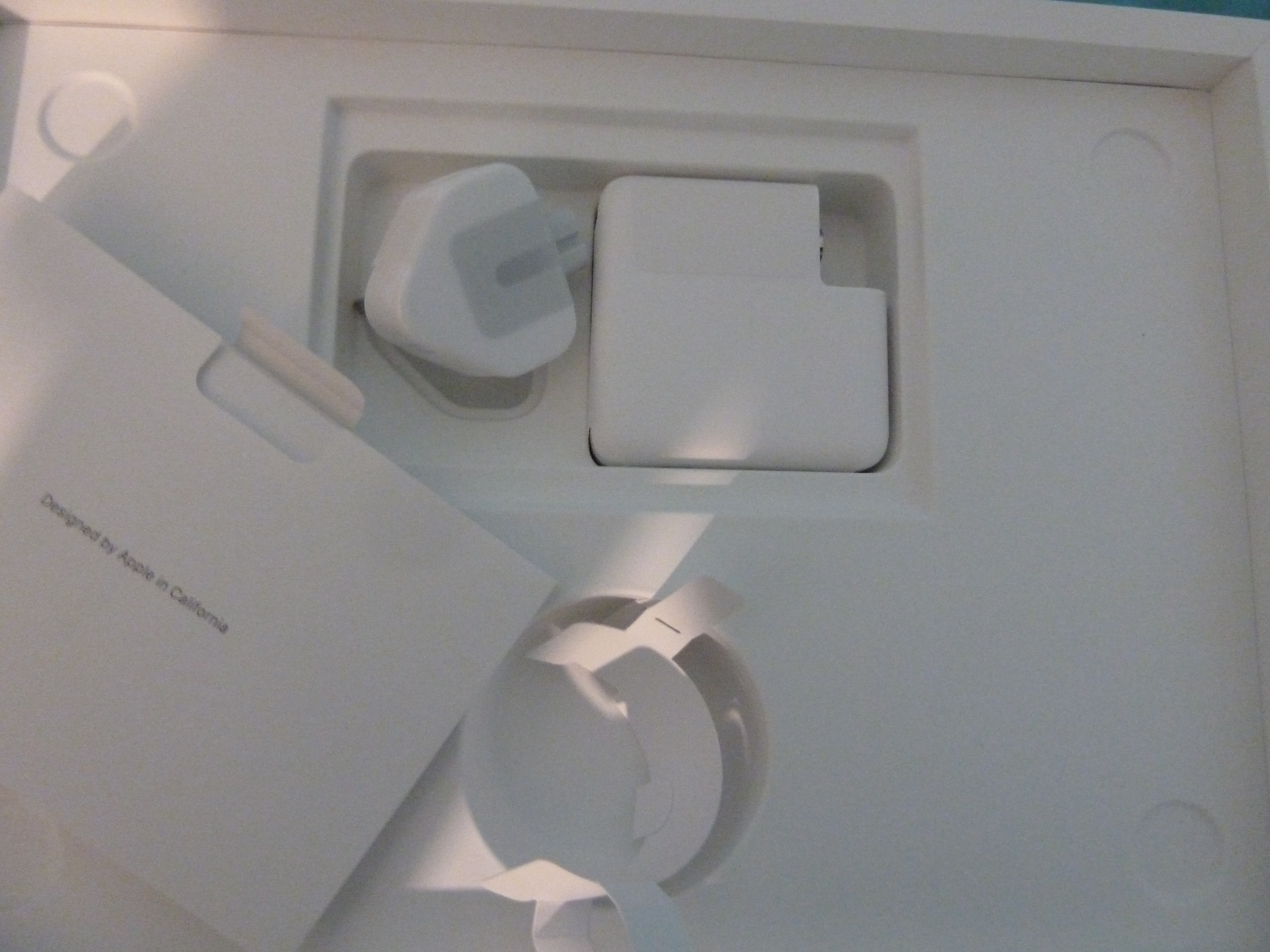 Photo of the box opened, showing power and documentation