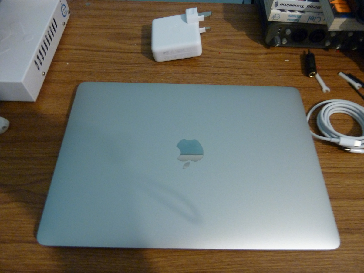 Photo of the MacBook Pro on my desk, about to be plugged in