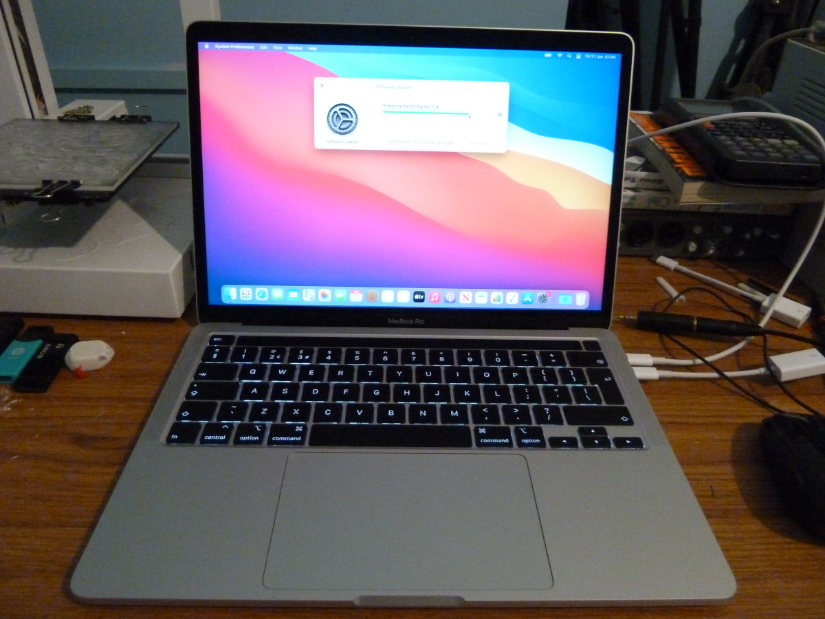 Photo of the MacBook Pro switched on and updating the software